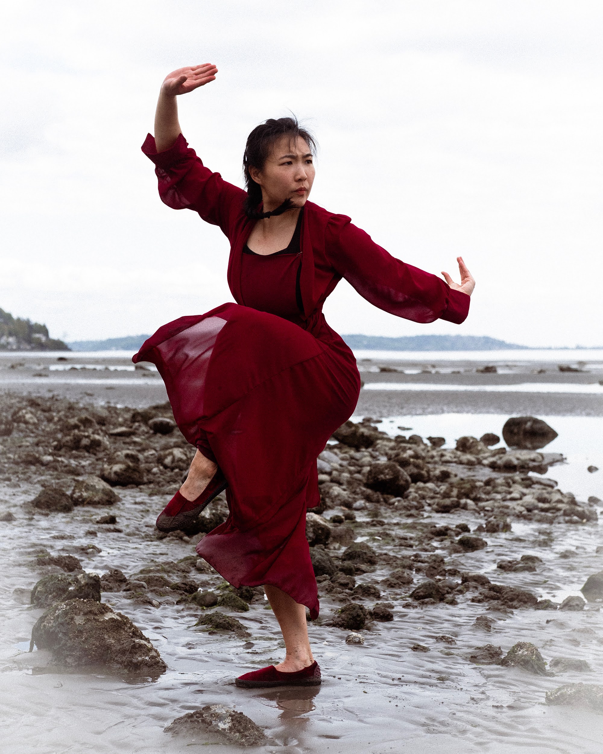 Crane balance kick on a rocky beach