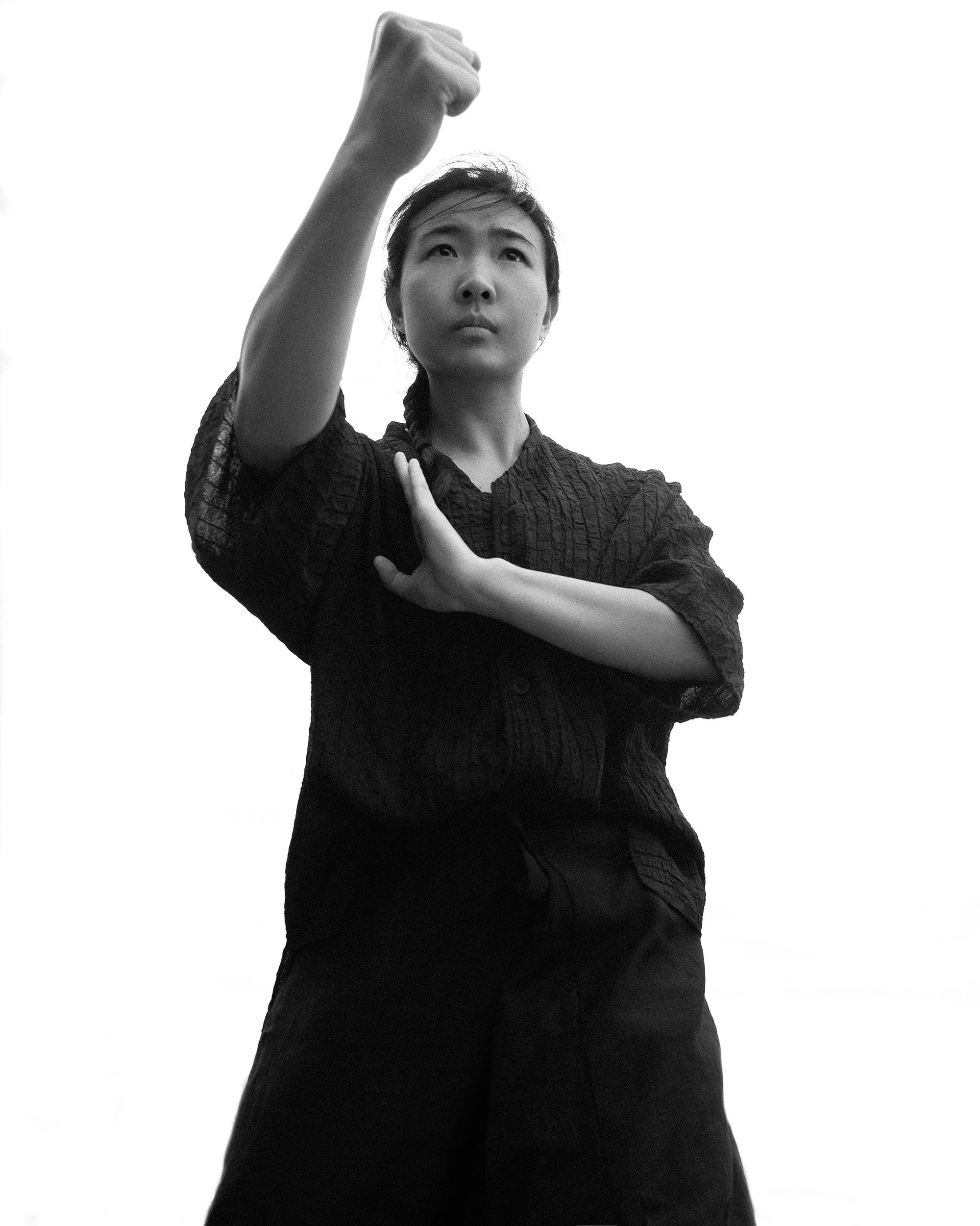 Black and white low-angle fist salute pose