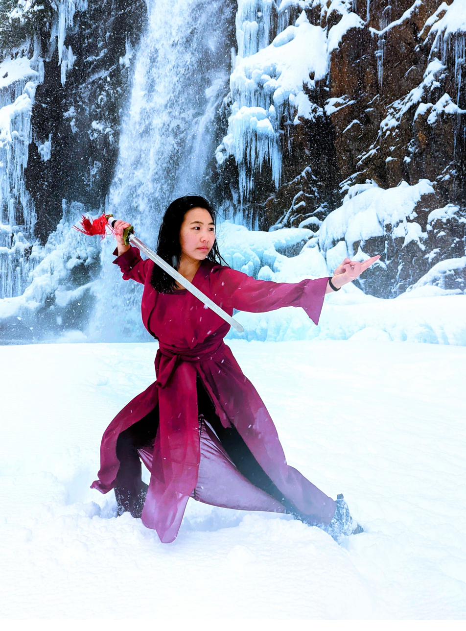 Spear form in front of a frozen waterfall